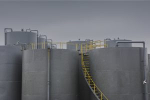 gray industrial tanks with yellow manway